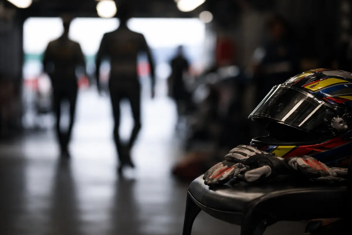 Casco e guanti su una sedia in un box di motociclette